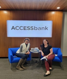 ACCESSbank team members sitting in chairs, at a high school career event.